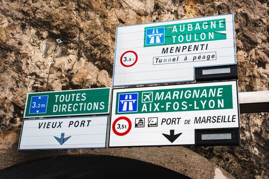 French road signs directing to aubagne, toulon, vieux port, and marseille tunnel payage