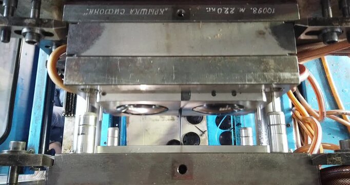 Injection molding thermoplastic machine, close-up. The process of creating a plastic part by injection molding. A modern plastic molding plant, inside. Process of compression molding of plastic parts 