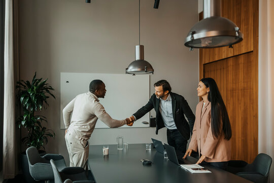 Male manager doing handshake with candidate after interview at office
