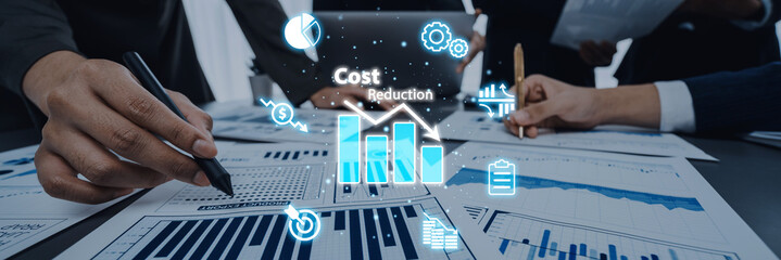 A professional team conducting a business meeting focused on cost reduction strategies, analyzing...