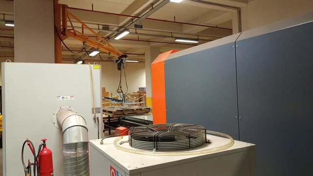 General view of a professional CNC laser cutting machine in a modern metal factory.
