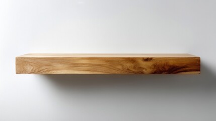 Minimalist floating wooden shelf with natural grain texture against a clean white wall