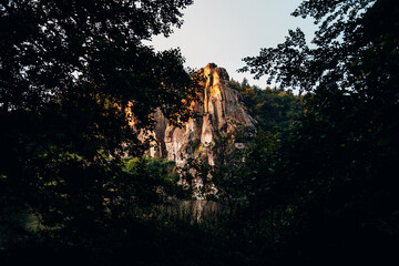 The Externsteine Rock Formation at Sunrise, Ancient Sandstone Pillars Glowing in Golden Morning Light