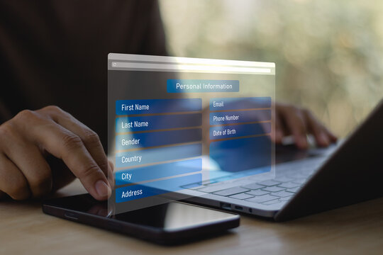 User entering personal information on online registration form via laptop and smartphone. Digital data privacy, cybersecurity, identity verification and secure account signup concept.