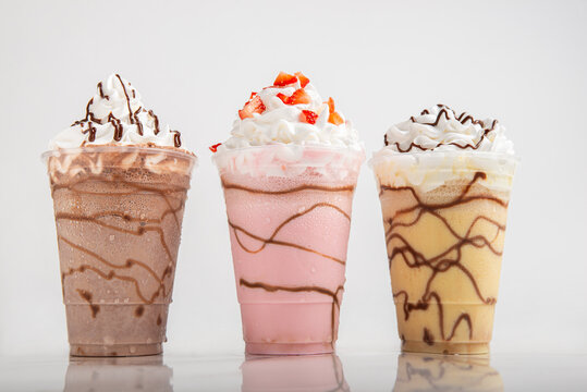 Milkshakes of different flavors on a white background.