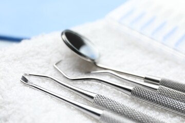 Different dental tools and towel on table, closeup