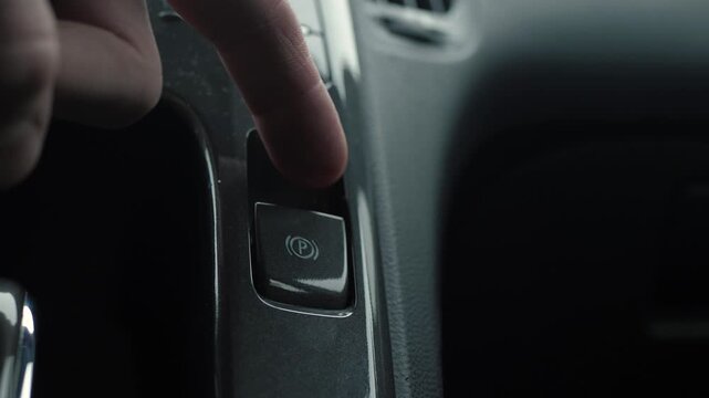 Enable vehicle parking support feature. Driver initiates car parking assistance system activation. Activation of vehicle parking system occurs when driver presses designated control button on console