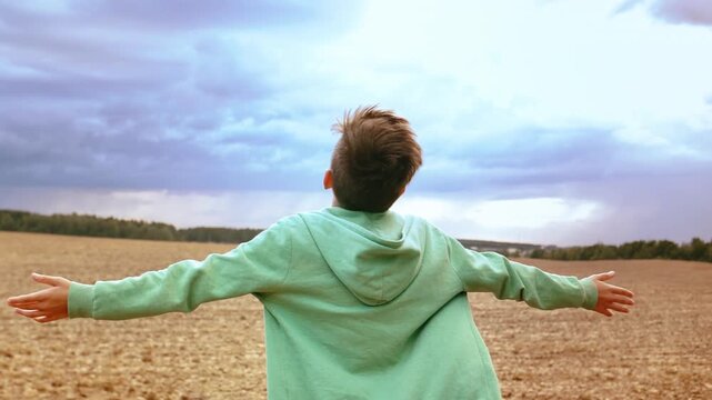 Sunlit Dream: Boy Embracing Sunlight and Gazing Upward in Awe