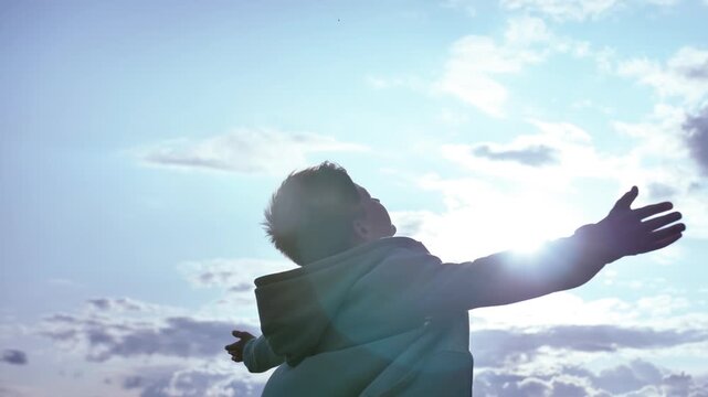 Sunlit Wonder: Boy Lost in Awe as He Embraces the Sunlight and Gazes Upward