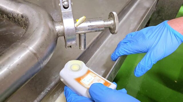 Quality Control Specialist Testing Soy Milk Density with Refractometer