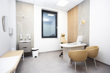 Modern medical consultation room interior with desk, chairs and examination bed. Clean clinic office for patient visits. Healthcare facility space designed for diagnostics and professional care. © Paweł Michałowski