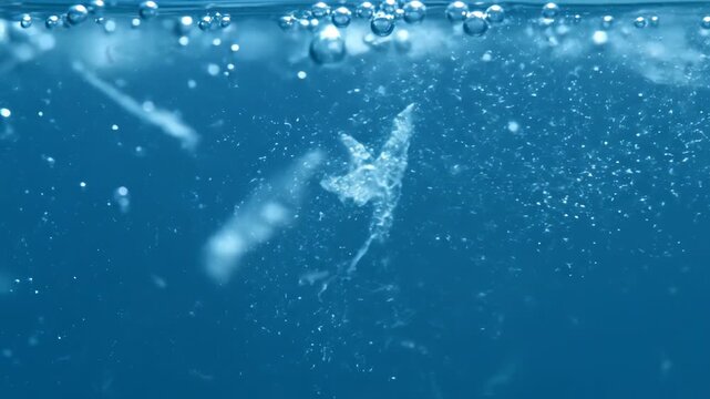 Transparent liquid bubble on blue water surface clear underwater depth perspective