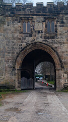 Naklejka premium Whalley Abbey gatehouse. Stone gate to the old abbey. Open stone gate