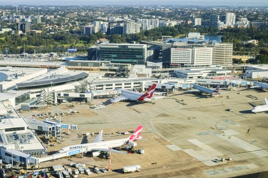 Sydney, Australia - 19 July, 2025: aerial view of QANTAS planes waiting to waiting to board passengers on a sunny winter morning at Kingsford Smith International Airport, New South Wales