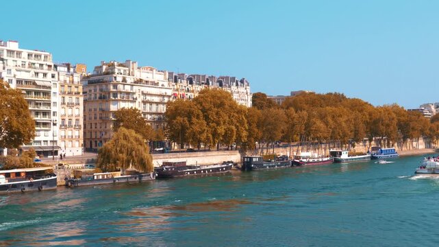 A shot from the Bir-Hakeim bridge shows buildings in the background and the Seine River. Paris, France.