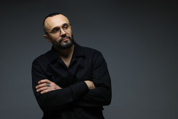 Fototapeta premium Fashion model. Handsome man in glasses on grey background, space for text