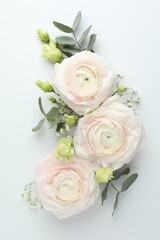 Naklejka premium Beautiful ranunculuses and roses on white background, flat lay