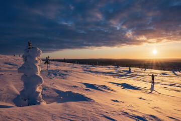 Hiking to the summit of Mount Kiilopää during a spectacular arctic sunset in Finnish Lapland. © julen