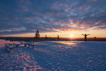Hiking to the summit of Mount Kiilopää during a spectacular arctic sunset in Finnish Lapland. © julen