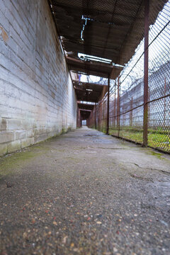 Lukiskes Prison corridor in Vilnius with brick wall and barbed fence