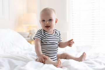 Fototapeta premium Cute little baby on bed at home