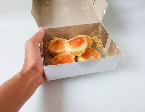 bakpia jogja. typical souvenirs of jogja. bakpia with green bean flavor in a box that is isolate on white. concept of food souvenirs.