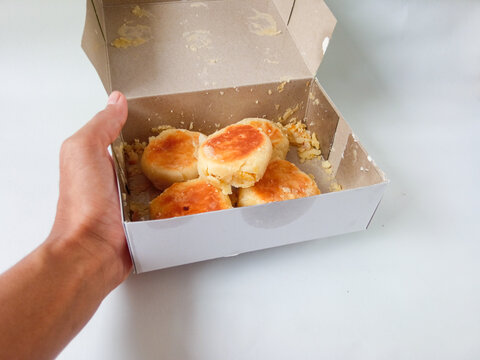 bakpia jogja. typical souvenirs of jogja. bakpia with green bean flavor in a box that is isolate on white. concept of food souvenirs.