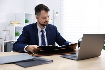 Fototapeta premium Notary working at wooden desk in office