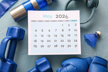 Composition with paper calendar, sports equipment and bottle of water on color background
