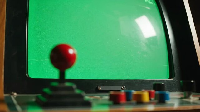 Close-up of Vintage Arcade Game Screen with Red Joystick and Buttons
