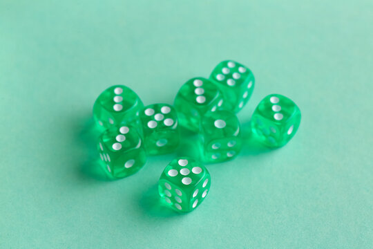 Green game dices on turquoise background