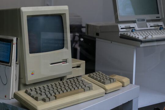 Boston, USA - 20 December 2025. Vintage Macintosh and IBM desktop computers with keyboards displayed in a technology workspace setting.