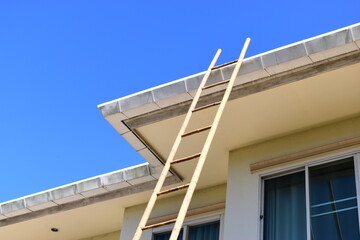 wood ladder for repair house's gutter before rainy season