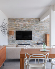 Modern open plan living room with dining area in bright apartment.