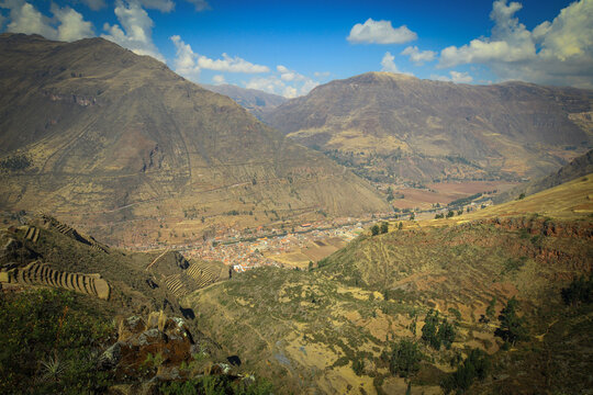 "Aerial panoramic view of Pisac Inca ruins and agricultural terraces in the Sacred Valley, high angle landscape of Andean mountains, Cusco, Peru."