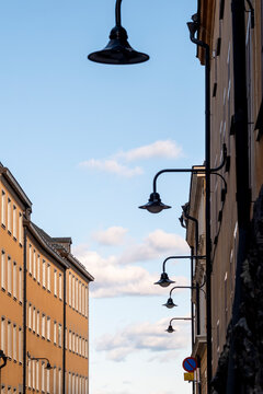 Minimal sky and rising street lamps complement historic urban architecture with Sodermalm facade in Stockholm Sweden around a Scandinavia building