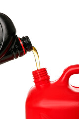 Naklejka premium Pouring of gasoline from bottle into canister on white background