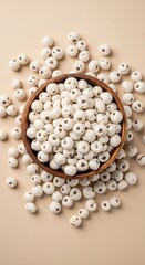 High-angle shot of crunchy makhana snacks filling a wooden bowl, surrounded by loose seeds on beige.