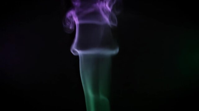 Abstract Colorful Smoke Swirls Against Black Background.