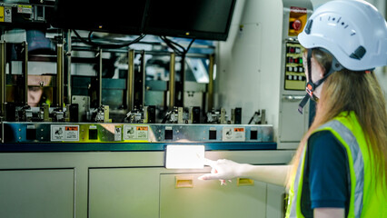 Obraz premium A female engineer represents the future of work, using artificial intelligence and robotics to optimize production. She is innovating for the high tech manufacturing supply chain.