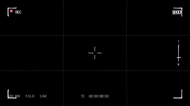Black and white video screen animation with white cross symbol, ISO 800 F/2.8 1/60, and timestamp