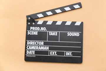 Obraz premium Movie clapper on beige background