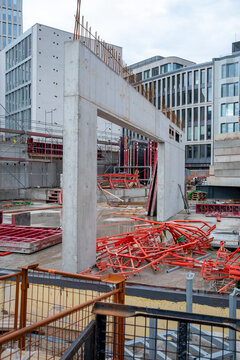 Concrete framework at urban construction site with building structure and crane showing development infrastructure and heavy industry work in progress