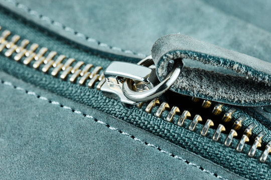 Macro of Metal Zipper on Blue Suede Leather
