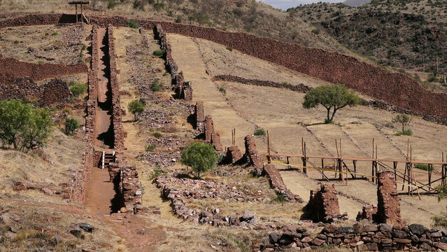 "High angle view of the Pikillacta archaeological site, an ancient Wari culture pre-Inca city with stone walls and grid layout, Cusco, Peru."