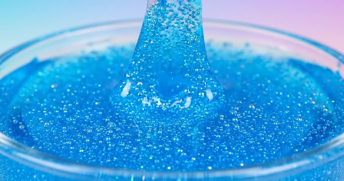 blue slime being manipulated by fingers.