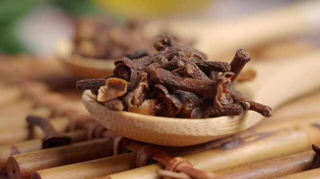 Cloves on wooden spoons in kitchen setting