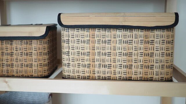 Storage boxes on shelf in simple design for organization