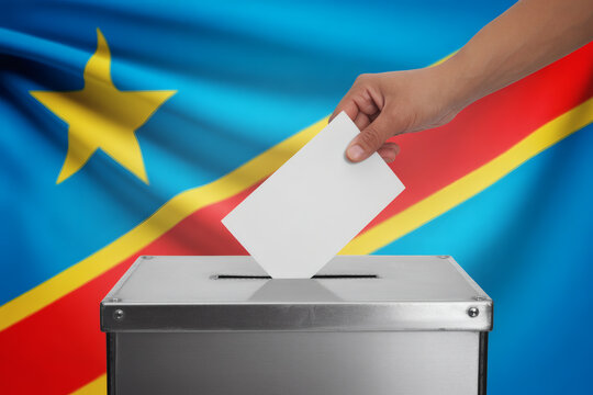 Democratic Republic of the Congo voter casting ballot for free and fair elections with national flag waving in the background