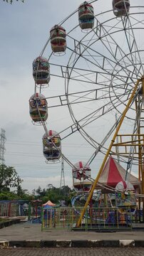 Aerial view of playground park at outdoor with blurred background. Object videography concept design. Ferriswheel at public place. Footage video at night market.